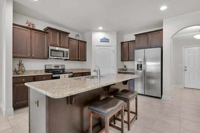 1729 Waterford Sound Blvd, Gulf Breeze, FL 32563 - kitchen featuring stainless steel appliances, sink, a center island with sink, and dark brown cabinetry