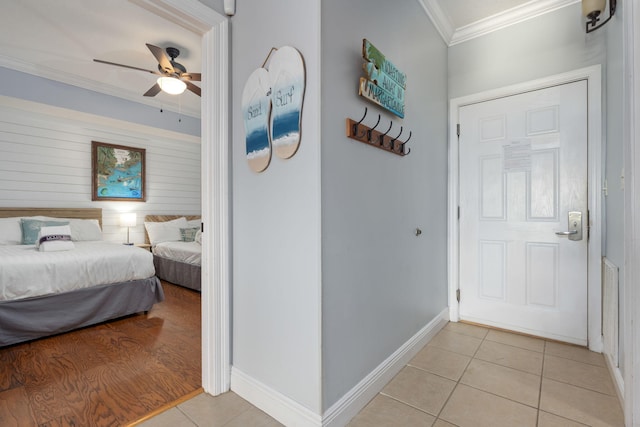 bedroom with crown molding, ceiling fan, and light tile patterned flooring