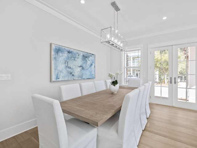 dining room featuring recessed lighting, baseboards, light wood-style floors, french doors, and ornamental molding