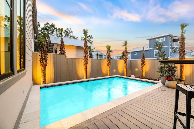 pool at dusk with a deck