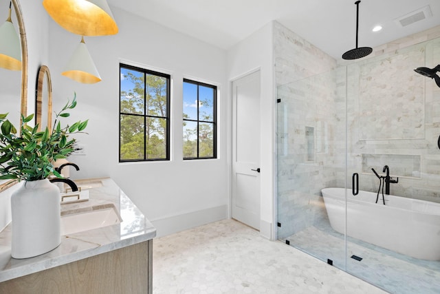 bathroom with vanity and independent shower and bath