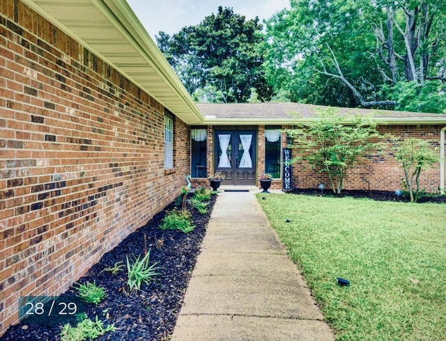 property entrance with french doors and a lawn