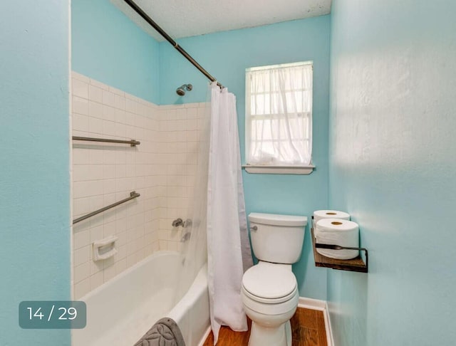 bathroom with hardwood / wood-style flooring, toilet, and shower / tub combo