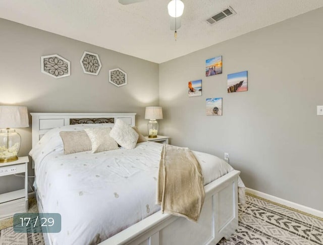 bedroom featuring ceiling fan and a textured ceiling