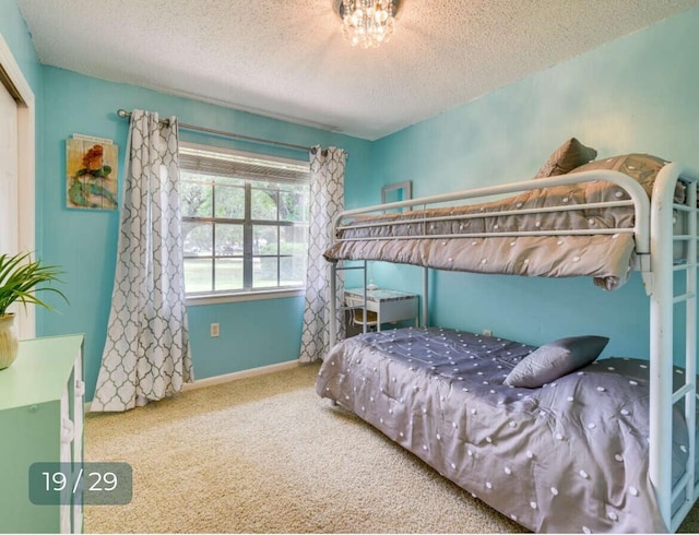 bedroom with carpet floors and a textured ceiling