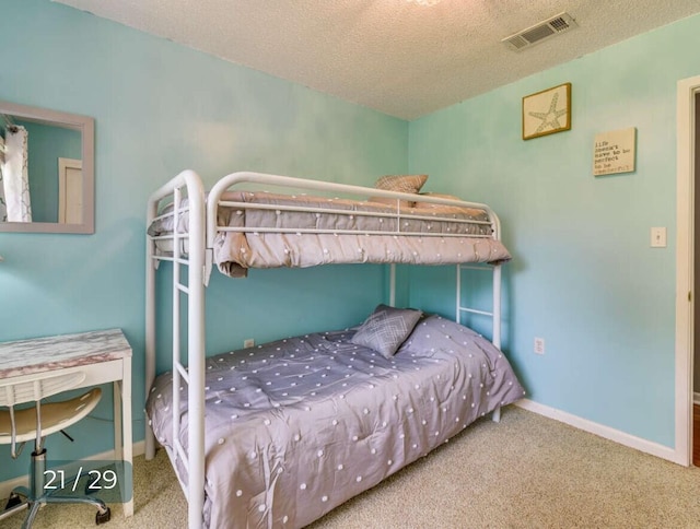 carpeted bedroom with a textured ceiling