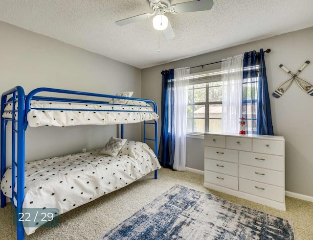 bedroom featuring ceiling fan, light carpet, and a textured ceiling