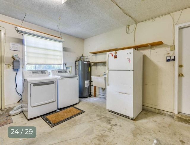 laundry area with water heater, sink, washing machine and clothes dryer, and a textured ceiling