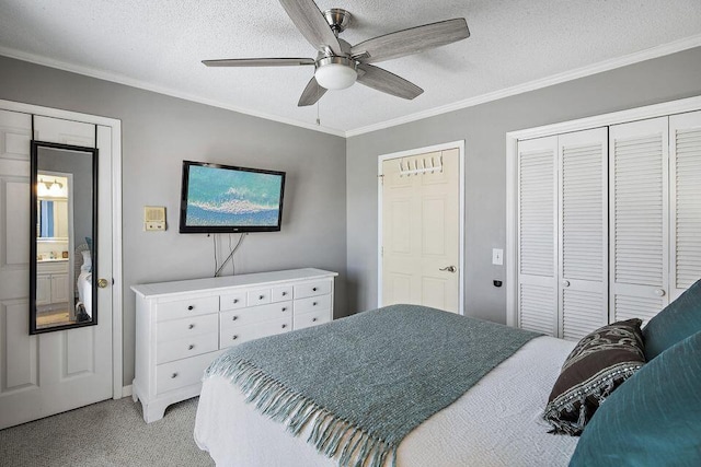 carpeted bedroom with ornamental molding, ceiling fan, and a textured ceiling
