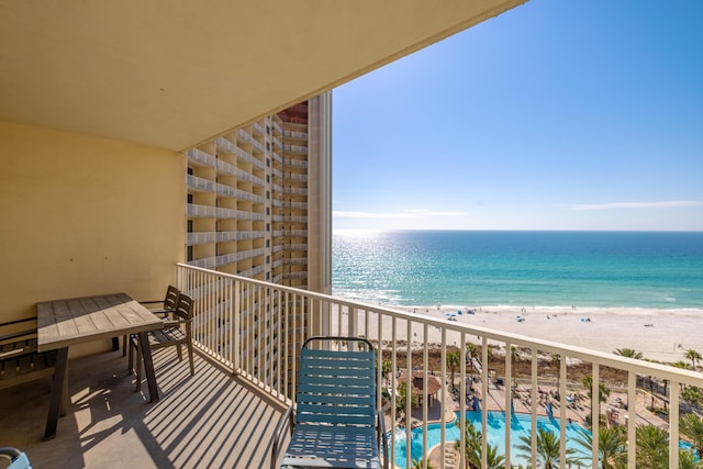 balcony featuring a water view and a beach view