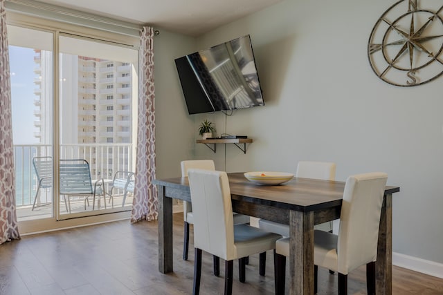 dining area with plenty of natural light and dark wood-type flooring