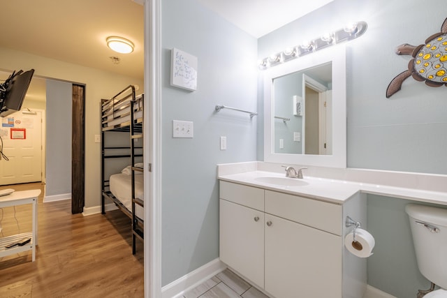 bathroom featuring vanity, hardwood / wood-style floors, and toilet