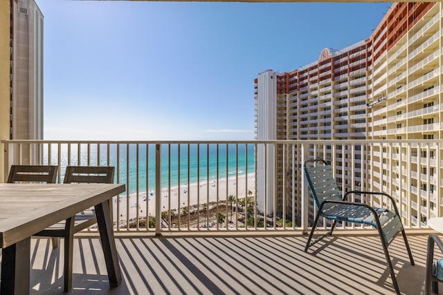 balcony with a water view and a beach view