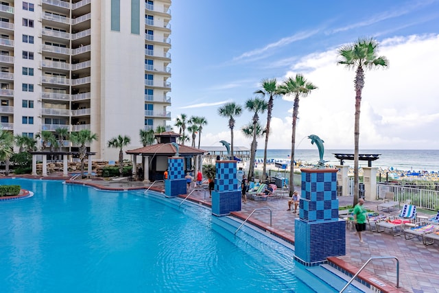 view of swimming pool with a gazebo, a water view, and a patio area