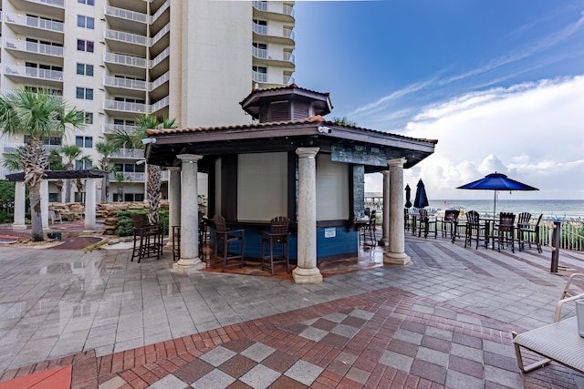 view of patio featuring a gazebo and a water view