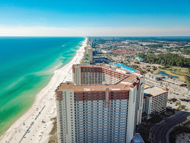 birds eye view of property with a water view and a beach view