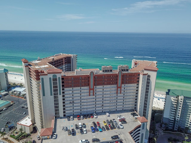 drone / aerial view with a beach view and a water view