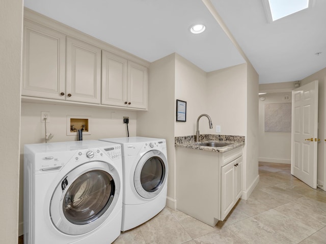 clothes washing area featuring recessed lighting, cabinet space, a sink, separate washer and dryer, and baseboards