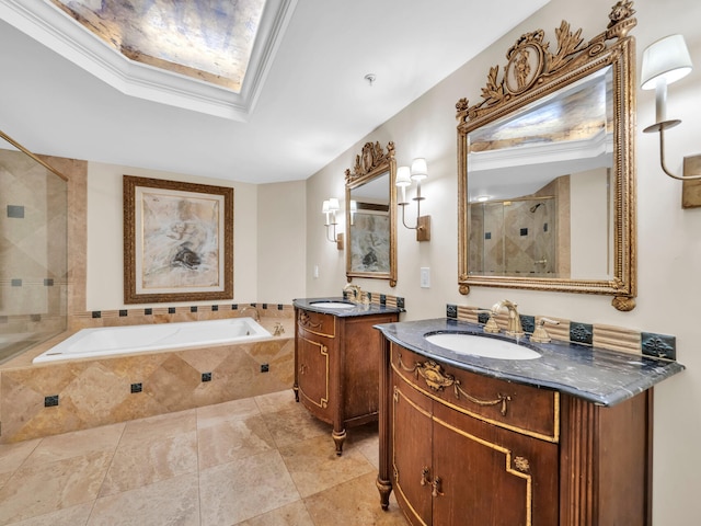 full bath featuring a garden tub, a stall shower, a skylight, and a sink