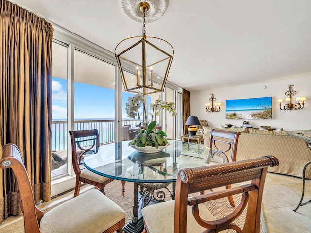 dining area with floor to ceiling windows, a water view, and an inviting chandelier