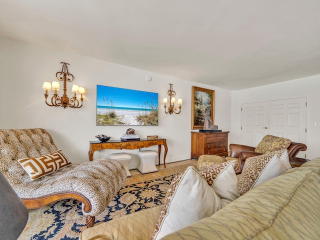 living area featuring a chandelier and baseboards