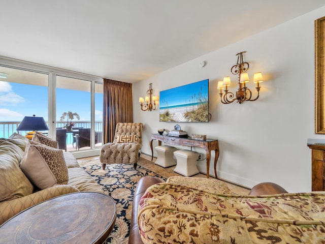 living area with baseboards and a notable chandelier