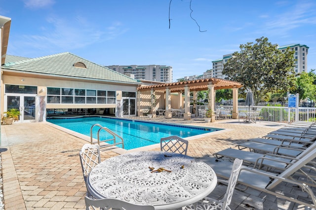 community pool with fence, a pergola, and a patio