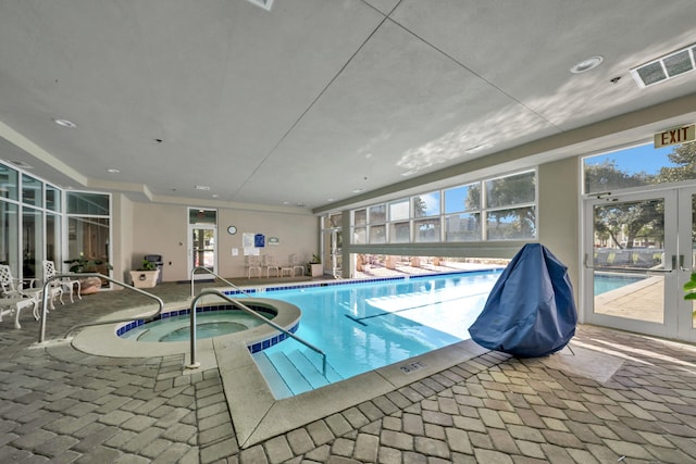 community pool featuring french doors and an indoor in ground hot tub