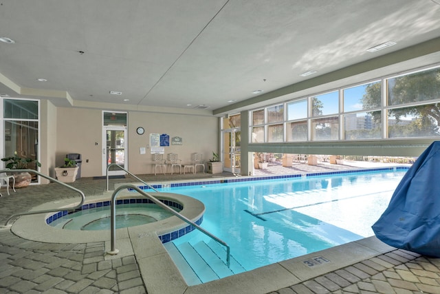 community pool with an indoor in ground hot tub