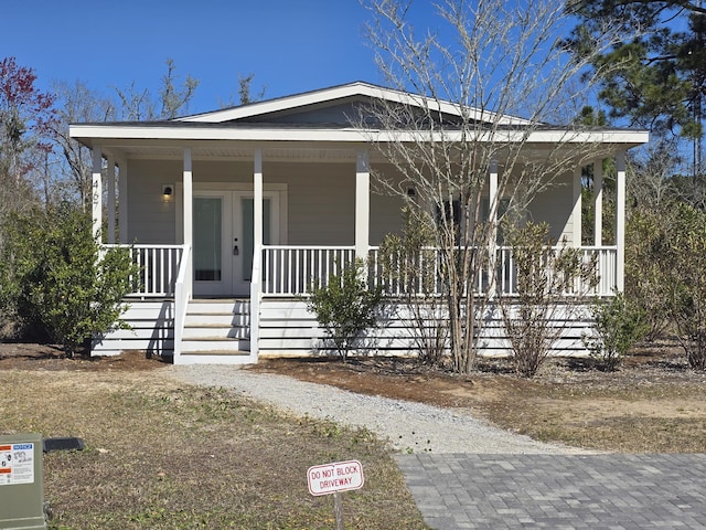 view of front facade with a porch and french doors