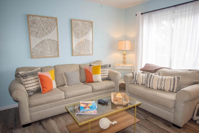 living area featuring baseboards and wood finished floors