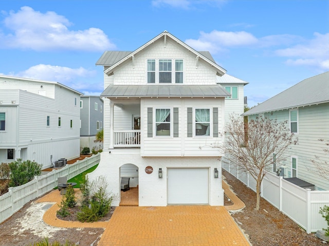 view of front of home with a garage and central air condition unit