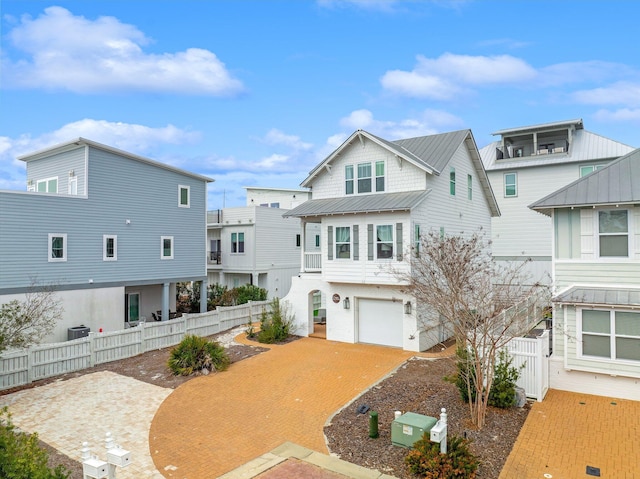 view of front of house featuring a garage and central AC