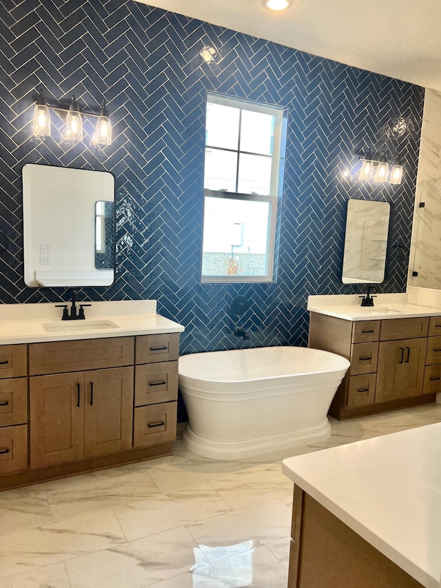 full bath featuring marble finish floor, tile walls, and a sink