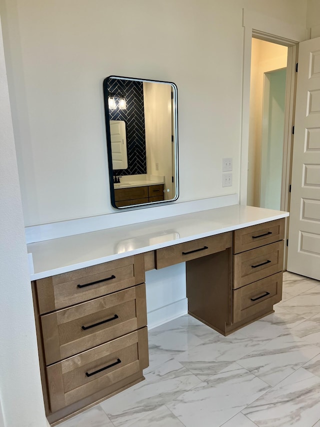 bathroom with marble finish floor and vanity