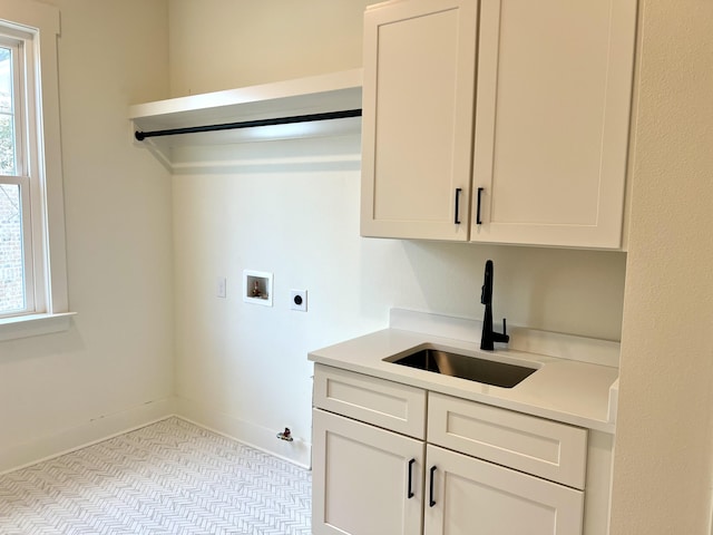 clothes washing area with washer hookup, a healthy amount of sunlight, a sink, and electric dryer hookup