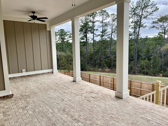 view of patio with a wooden deck, fence, and a ceiling fan