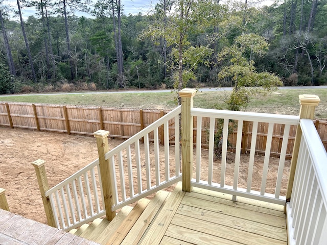 wooden deck with fence and a forest view