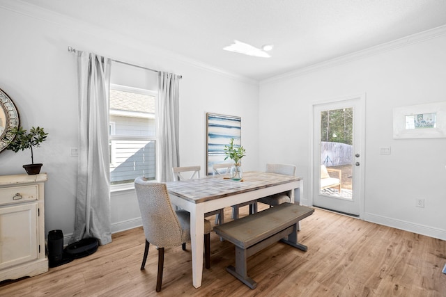 dining area featuring crown molding and light hardwood / wood-style flooring