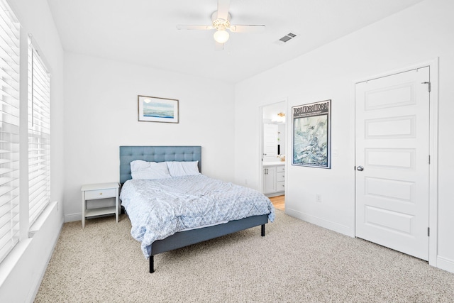 bedroom featuring ceiling fan and ensuite bathroom