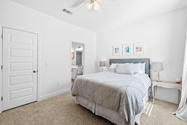 bedroom featuring ensuite bathroom, ceiling fan, and carpet flooring