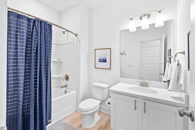 full bathroom featuring vanity, hardwood / wood-style floors, shower / tub combo with curtain, and toilet