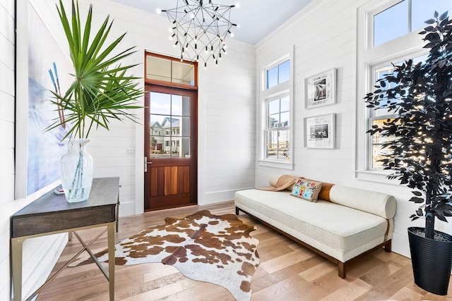 sitting room with hardwood / wood-style floors and a notable chandelier