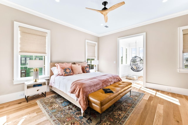 bedroom featuring crown molding, ceiling fan, and light wood-type flooring