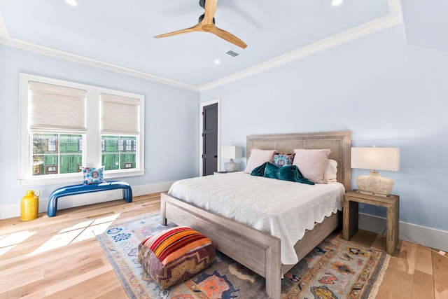 bedroom featuring hardwood / wood-style flooring, crown molding, and ceiling fan