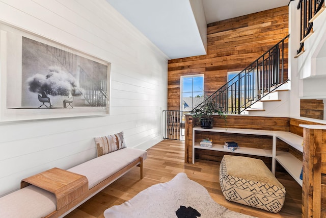 living area with wood walls and light hardwood / wood-style flooring