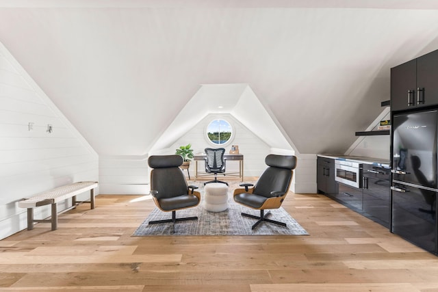 sitting room featuring lofted ceiling and light hardwood / wood-style floors