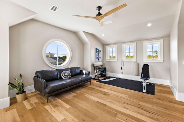 interior space with ceiling fan, a wealth of natural light, vaulted ceiling, and light wood-type flooring