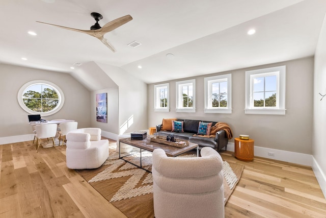 living room featuring lofted ceiling, ceiling fan, and light hardwood / wood-style flooring