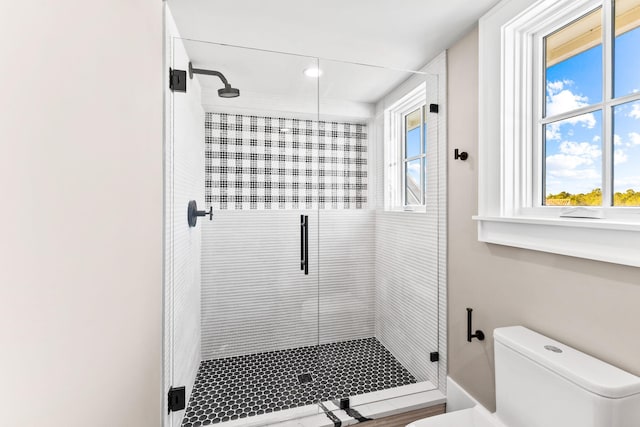 bathroom featuring toilet and walk in shower